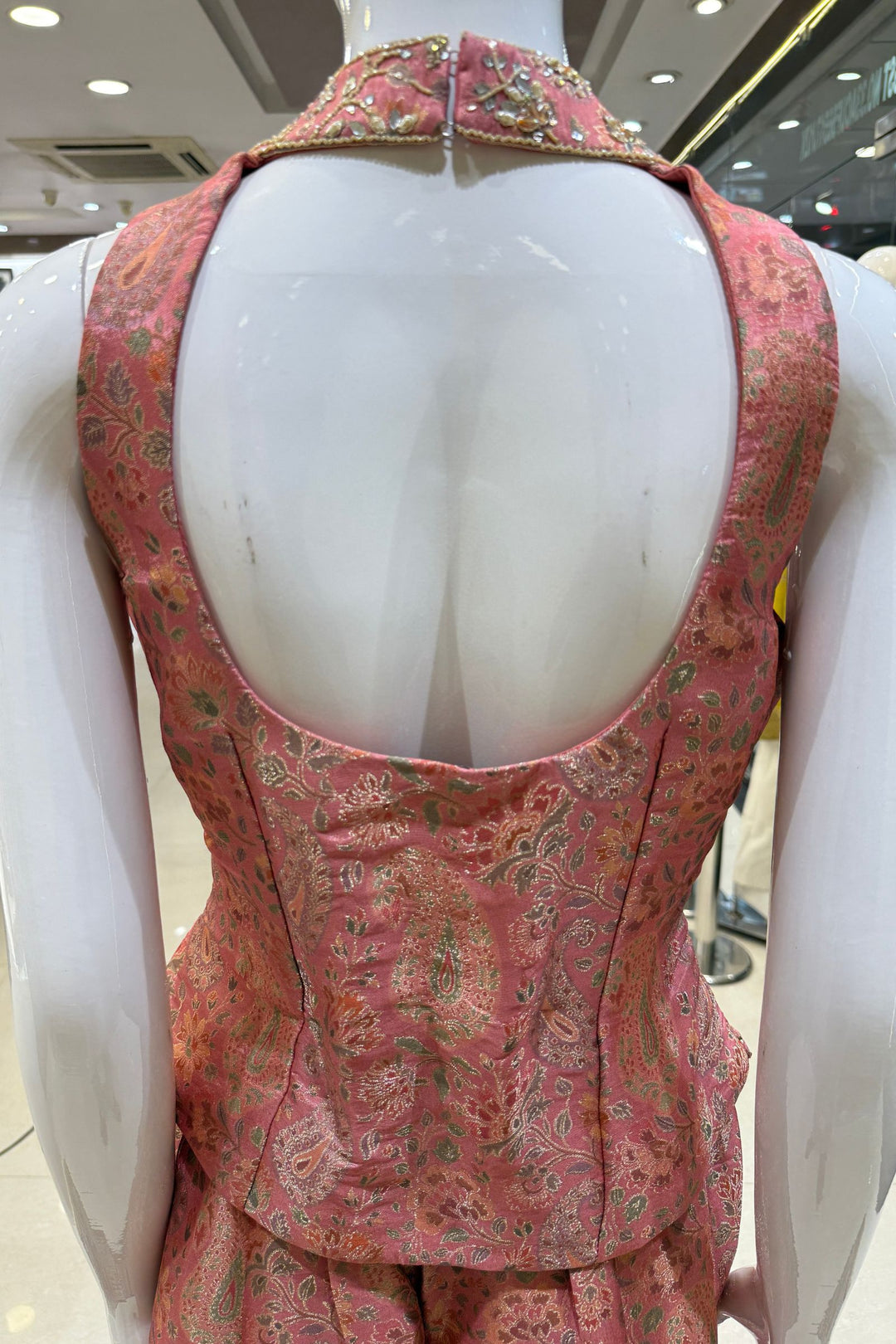Peach Halter Neck Palazzo Salwar Suit with Multicolor Brocade and Sequins Detailing